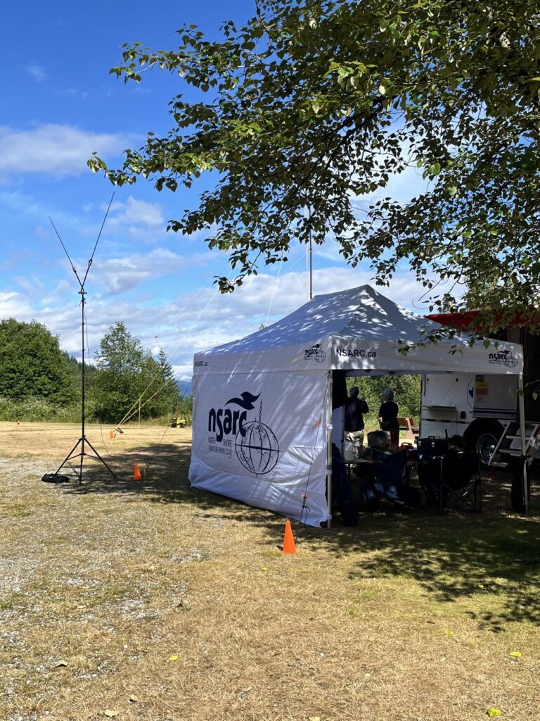 The tent in full swing, with Vince’s dipole on its tripod at the ready for the Elecraft demonstration. Photo: Janice (VA7JMO)